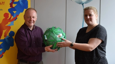 Jürgen Ungerer vom Blauen Kreuz initiiert zusammen mit Veronika Polok (Caritas) die Ausstellung zum Thema Sucht im evangelischen Gemeindezentrum Neustadt. In Händen halten sie ein Exponat der Ausstellung. Die Plüschtiere stehen für die Mitglieder der Selbsthilfegruppe. (Foto: Ute Niephaus)