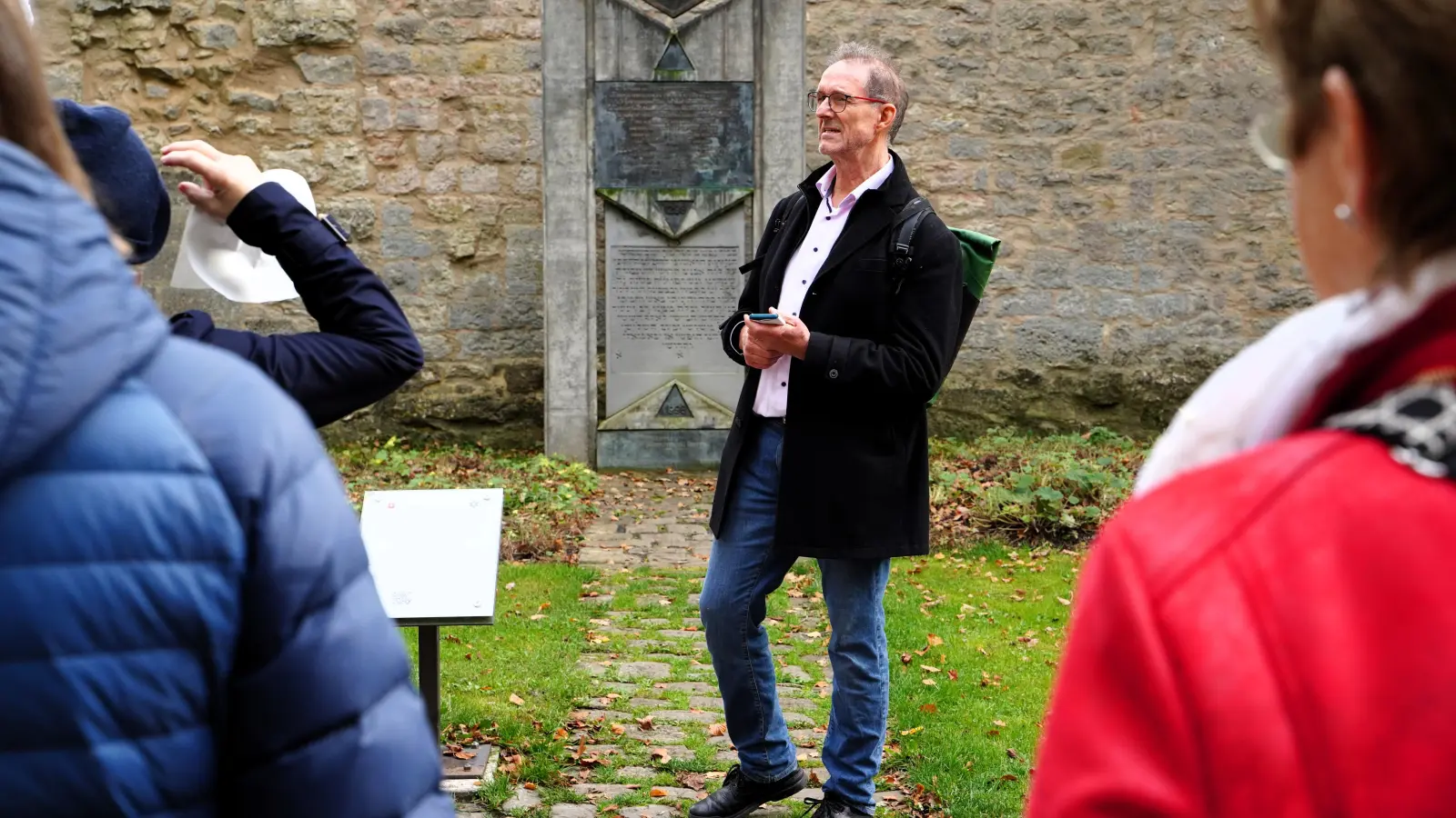 Im Burggarten erinnert ein Gedenkstein an das Rintfleischpogrom, bei dem zahlreiche jüdische Menschen in Rothenburg ermordet wurden. Das Foto zeigt Dr. Oliver Gußmann bei seiner Führung. (Foto: Simone Hedler)