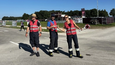 Erwarten auf der Staatsstraßenkreuzung die Fahrzeuge mit dem Gruß der Metal-Fans (von links): Michael Brandner, André Beck und Lena Schmidt gehören zu den über 40 Aktiven der Illenschwanger Feuerwehr, die während Summer Breeze dort für die Verkehrsregelung sorgen. (Foto: Martina Haas)