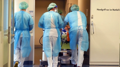 Mitarbeiter eines Klinikums in Leipzig fahren einen Patienten zur Untersuchung mit einem Computertomographen. (Foto: Waltraud Grubitzsch/dpa-Zentralbild/dpa)