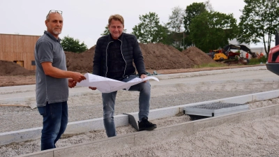 Farag Khodary (links) und Holger Hutmann im Süden des neuen Baugebiets: Vor dem Campus Feuchtwangen deuten die Einfassungen der Straßen und Gehwege bereits an, wie es später aussehen wird. (Foto: Antonia Müller)