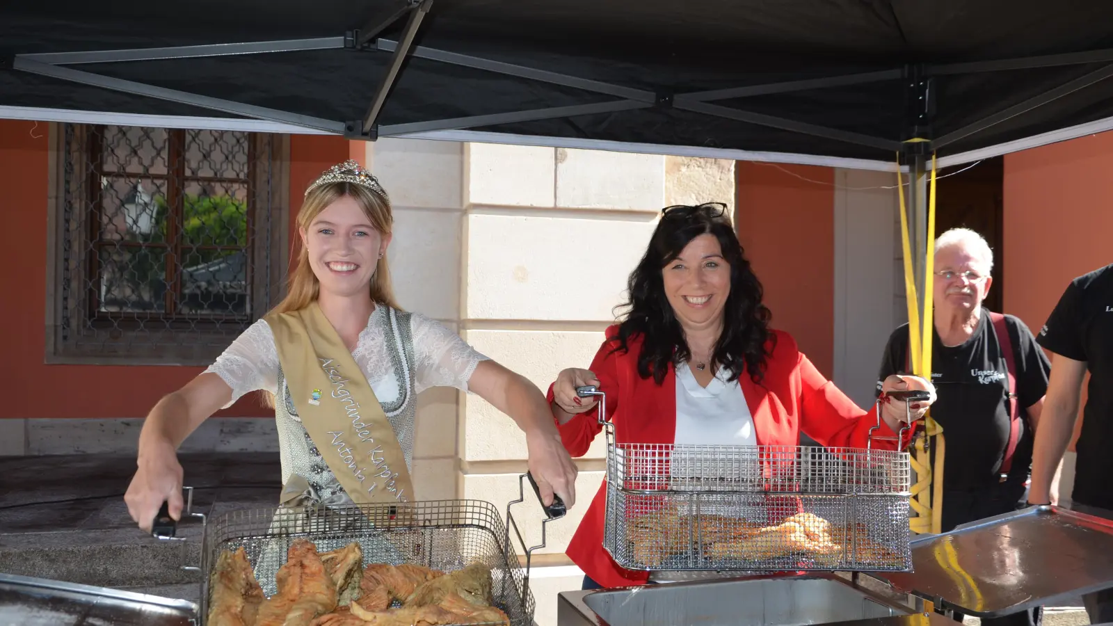 Die Karpfenkönigin Antonia Dümmler (links) und stellvertretende Bürgermeisterin Heike Gareis holten die frisch gebackenen Karpfen aus der Fritteuse.  (Foto: Christa Frühwald)