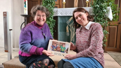 Zum Abschied hat Evelyn Beck-Pieler (rechts) ihrer Mentorin, Pfarrerin Christine Stradtner, ein Buch voller Erinnerungen gestaltet. (Foto: Anna Franck)