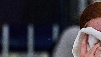 Ella Seidel vergräbt ihr Gesicht hinter einem Handtuch - Teamchef Rainer Schüttler tröstet. (Foto: Mathias Schulz/dpa)