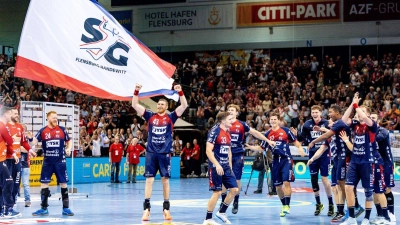 Die Spieler der SG Flensburg-Handewitt feiern den Sieg gegen den THW Kiel. (Foto: Axel Heimken/dpa)