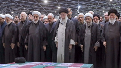 Abschied von Präsident Ebrahim Raisi, Außenminister Hussein Amirabdollahian und den weiteren beim Hubschrauberabsturz Getöteten: Irans Religionsführer Ajatollah Ali Chamenei (M.r.) spricht in Teheran an den mit Flaggen bedeckten Särgen ein Gebet. (Foto: Uncredited/Office of the Iranian Supreme Leader/AP/dpa)