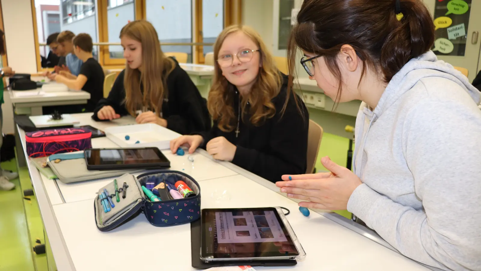 Jana Rotärmel, Theresa Däubler und Mareike Braun (von links) formen im Biounterricht an der Realschule Feuchtwangen Bakterien aus Knete nach der Vorlage in ihrem Tablet. (Foto: Thomas Schaller)