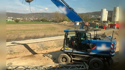 Der beschädigte Bagger steht an einer Baustelle neben den Bahngleisen. (Foto: Privat/dpa)