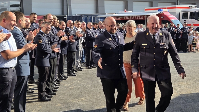 Alfred Tilz und seine Frau Brigitte wurden vom neuen Kreisbrandrat Florian Brandt (von rechts) durch ein Spalier von Feuerwehrführungskräften, Kommandanten und weiteren Honoratioren zur offiziellen Verabschiedung geleitet. (Foto: Rainer Weiskirchen)