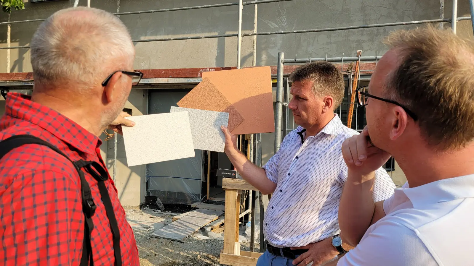 Vier Farben standen für den Fassadenanstrich des Medizinischen Versorgungszentrums (MZV) am Marktplatz in Burgbernheim zur Auswahl. Bürgermeister Matthias Schwarz (Mitte) zeigte die Farbmuster. (Foto: Nina Daebel)