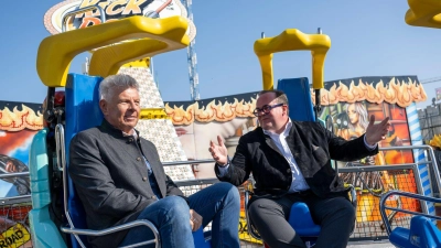 Der Oberbürgermeister und der Festleiter testen vor dem Wiesn-Start ein Fahrgeschäft. (Foto: Lennart Preiss/dpa)