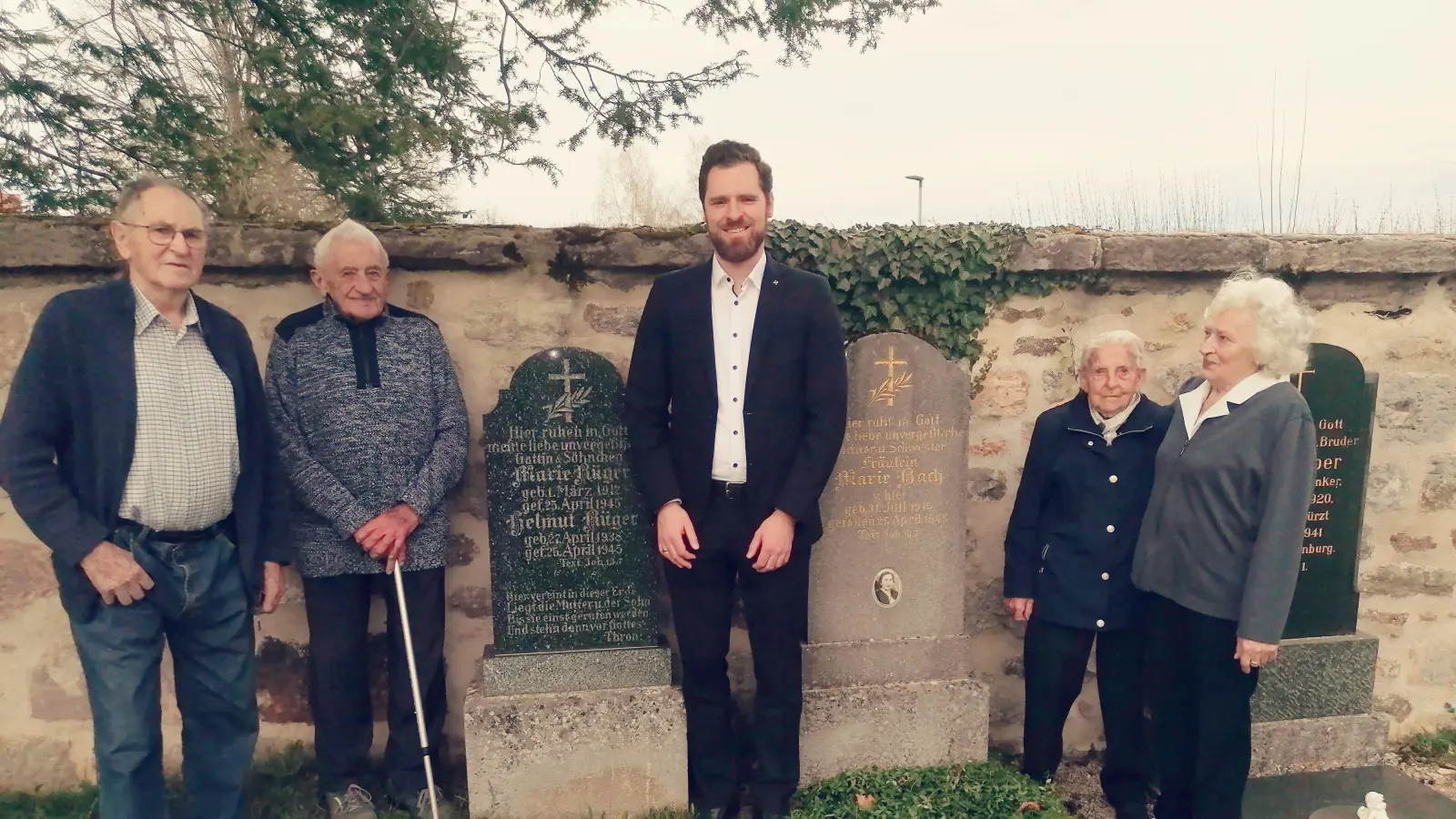 Pfarrer Simeon Prechtel (Mitte) zusammen mit den Zeitzeugen Friedrich Schäfer, Friedrich Carl, Lina Lehr und Frieda Dembelein (von links) an den Gräbern der drei Kriegsopfer. (Foto: Friedrich Zinnecker)