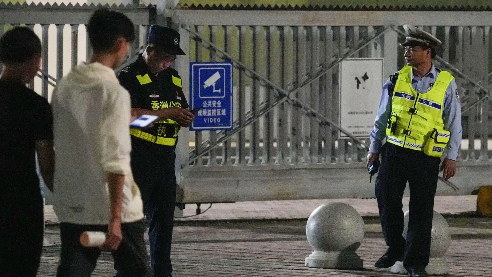 Sicherheitsbeamte stehen am Tor eines Sportzentrums Wache, wo ein Mann ein Auto in eine Gruppe von Menschen gefahren hat.  (Foto: kyodo/dpa)