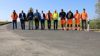 Und das Band ist durchschnitten: Stadtrat und Leuzenbronner Hermann Uhl (Vierter von links) und Oberbürgermeister Dr. Markus Naser (Fünfter von links) mit den an der Straßensanierung Beteiligten am Freitagvormittag. (Foto: Clarissa Kleinschrot)