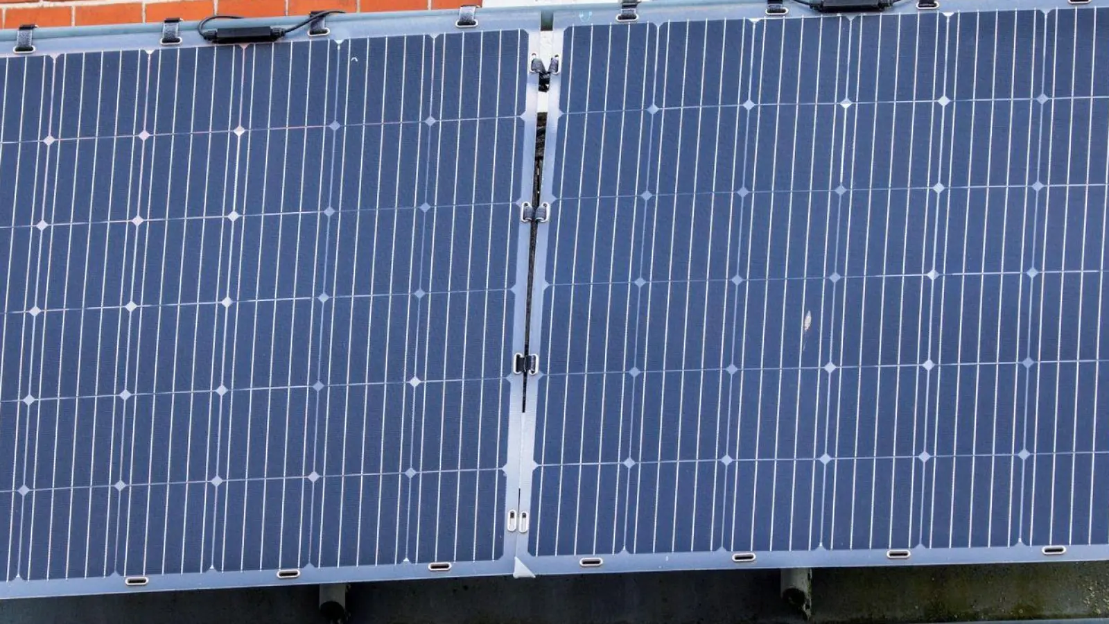 Solarmodule für ein sogenanntes Balkonkraftwerk an einem Balkon. (Foto: Jens Büttner/dpa)