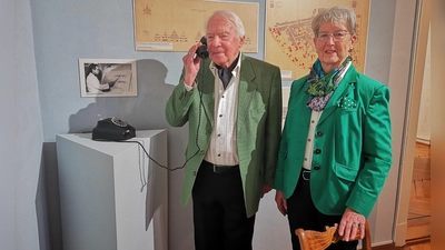 Zum Rothenburger Umgang mit dem Thema Wiederaufbau nach dem Krieg wurde für die Ausstellung auch der frühere Stadtbaumeister Michael Severini befragt. Das Gespräch mit ihm kann an einer Telefonstation abgehört werden. Mit seiner Frau Gisela probierte der 88-Jährige das selber aus. (Foto: Jürgen Binder)