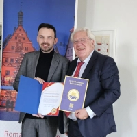 Oberbürgermeister Christoph Rösch (links) freut sich über die von Burkhard Graf Beissel von Gymnich überbrachte Auszeichnung des Reiterlesmarkts.  (Foto: Rothenburg Tourismus Service / Robert Nehr)