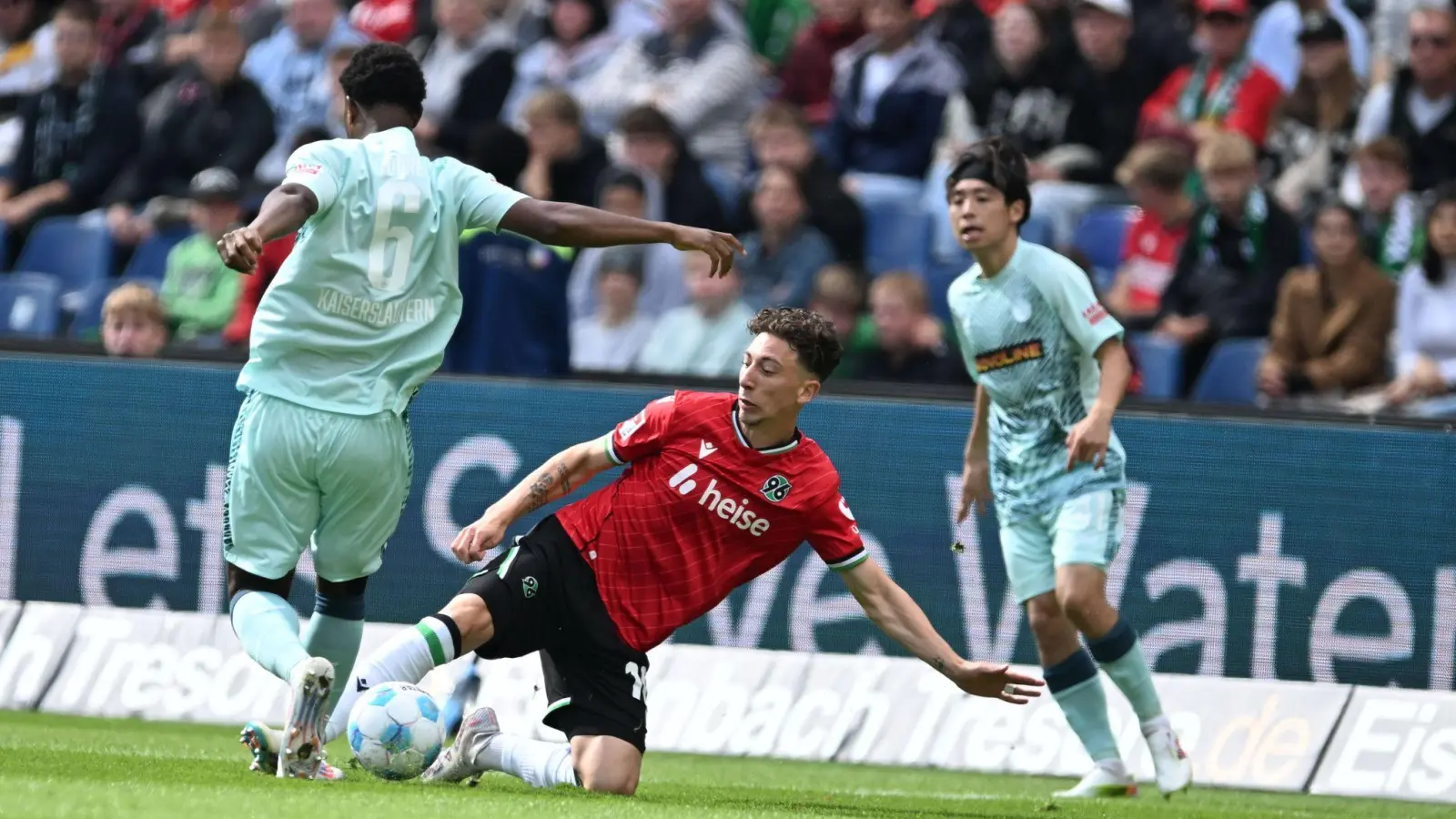 Voller Einsatz: Hannovers Jannik Rochelt (M) im Zweikampf mit Kaiserslauterns Almamy Toure (l) (Foto: Carmen Jaspersen/dpa)