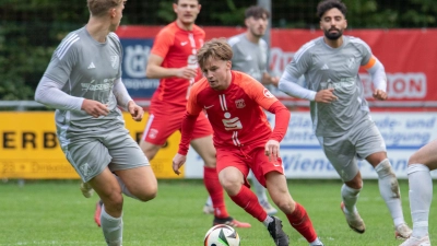 Der Dinkelsbühler Sebastian Kappler (in Rot) tankt sich durch die Reihen des TSC Neuendettelsau (links Simon Zenker, rechts Felipe Adler). (Foto: Markus Zahn)