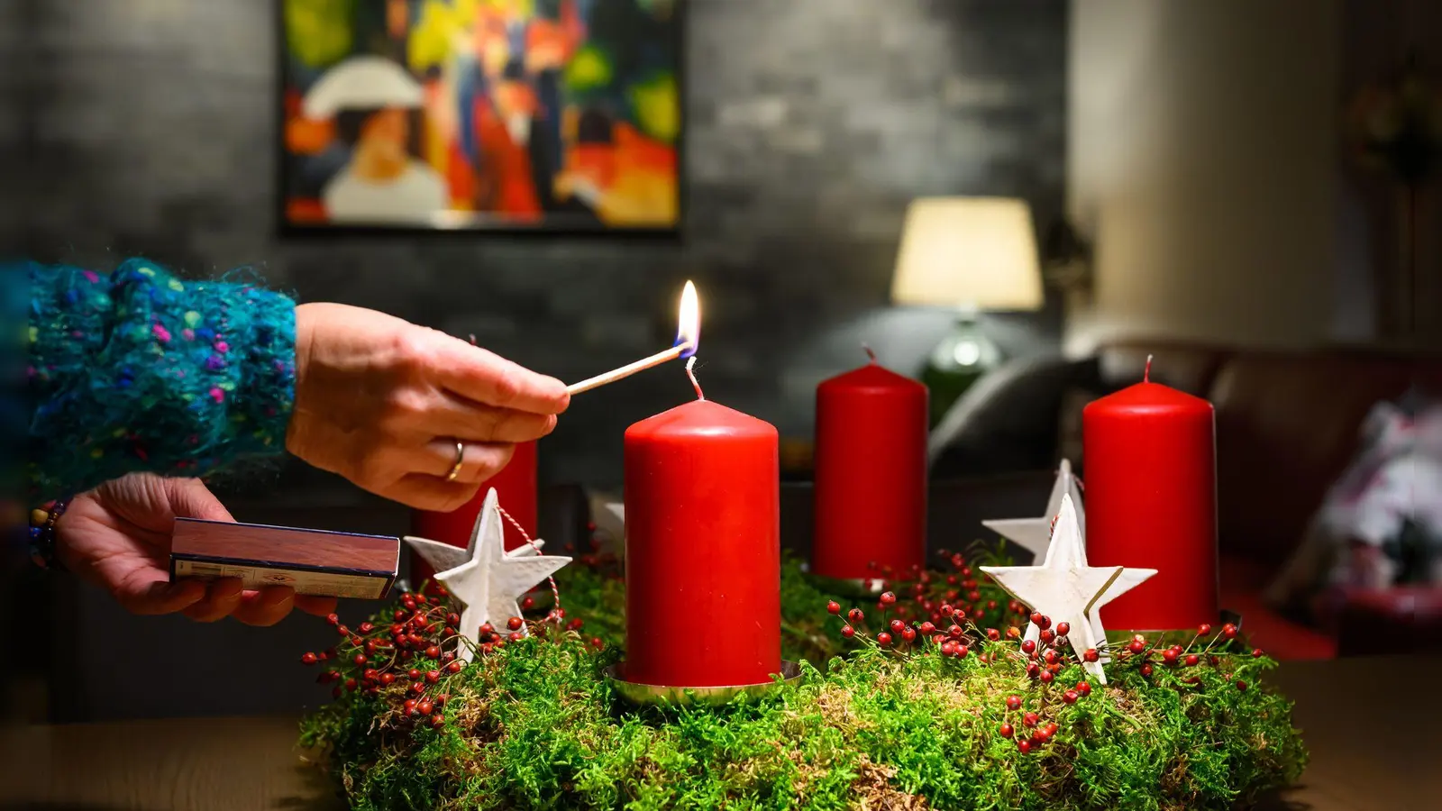 Advent, Advent, ein Lichtlein brennt: Regelmäßiges Besprühen mit Wasser und das Übernachten auf dem Balkon helfen, den Adventskranz länger frisch und weniger entflammbar zu halten. (Foto: Patrick Pleul/dpa/dpa-tmn)