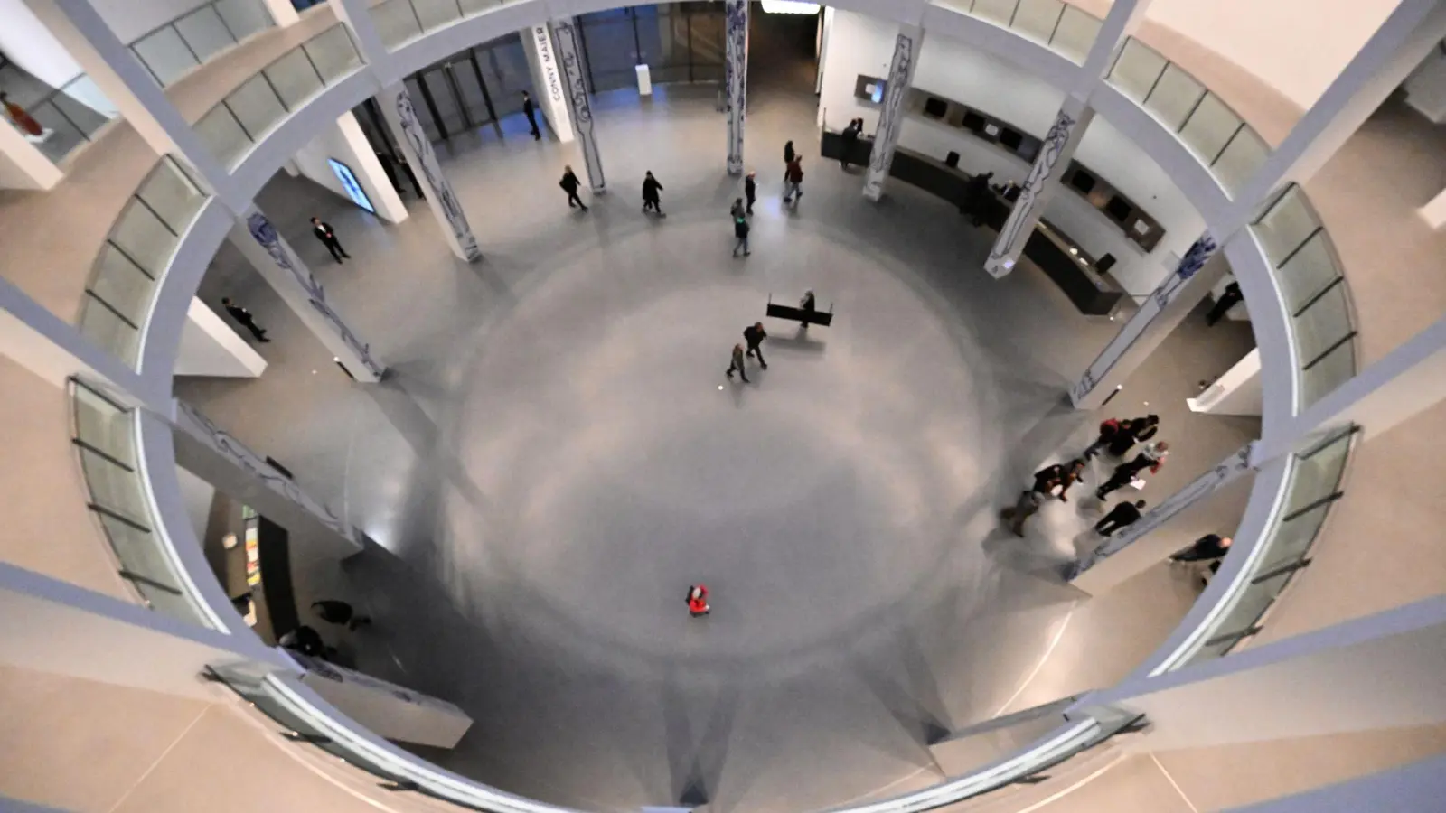 Besucher der Langen Nacht der Münchner Museen gehen durch die Rotunde der Pinakothek der Moderne. (Foto: Felix Hörhager/dpa)