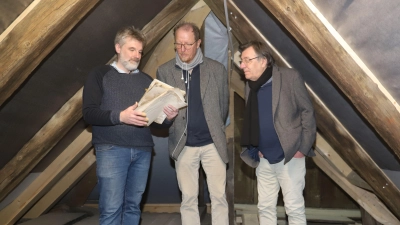 In dem Gefach rechts war Hauseigentümer Stephen Winter (links) auf die Dokumente gestoßen. Mit Fördervereins-Chef Dr. Christian Schoen (Mitte) und seinem Vize Eugen Ringhand sah er sie sich an. (Foto: Oliver Herbst)